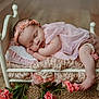 baby, sleeping, pink_dress, headband, small_bed, blanket, flower, wooden_floor, infant, peaceful, cute, newborn, soft_texture, decor, cozy, portrait, resting, skin, foot, hand
