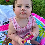Azalea joined the competition — help win amazing prizes! baby, child, infant, outdoor, grass, play_mat, toy, snack_pouch, pink_clothing, cute, chubby_cheeks, sitting, colorful, summer, food, happy, portrait, person, playtime, young