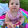 baby, child, infant, outdoor, grass, play_mat, toy, snack_pouch, pink_clothing, cute, chubby_cheeks, sitting, colorful, summer, food, happy, portrait, person, playtime, young