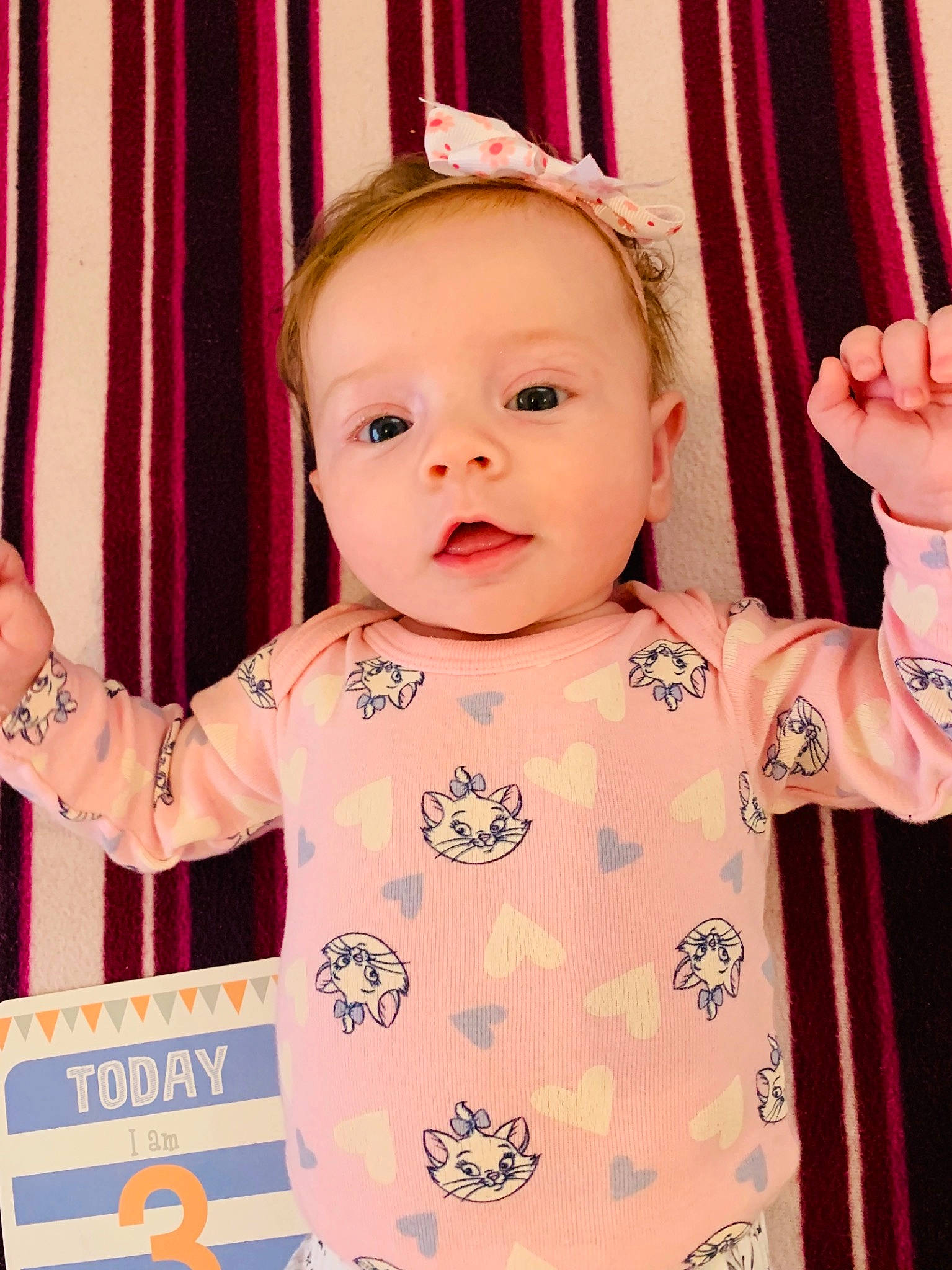 Meghan is registered to the contest to win money with this photo: baby, beauty, cheek, child, daughter, face, gesture, hand, head, nose, person, pink, product, room, skin, smile, toddler