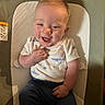 Harrison is registered to the contest to win money with this photo: baby, infant, smile, happy, child, sitting, clothing, shirt, pants, seat, baby_seat, indoor, cute, face, hand, light, shadow, expression, skin, hair