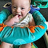baby, child, infant, smiling, sitting, baby_seat, colorful, finger_in_mouth, happy, indoor, carpet, clothing, toy, play, cute, person, young_child, home, comfort, seat
