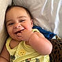 Levi joined the competition — help win amazing prizes! baby, child, smiling, hand, yellow_shirt, dinosaur_print, sun_print, cute, lying_down, happy, infant, fingers_in_mouth, soft_surface, couch, blue_blanket, leopard_print, cheerful, closeup, face, person
