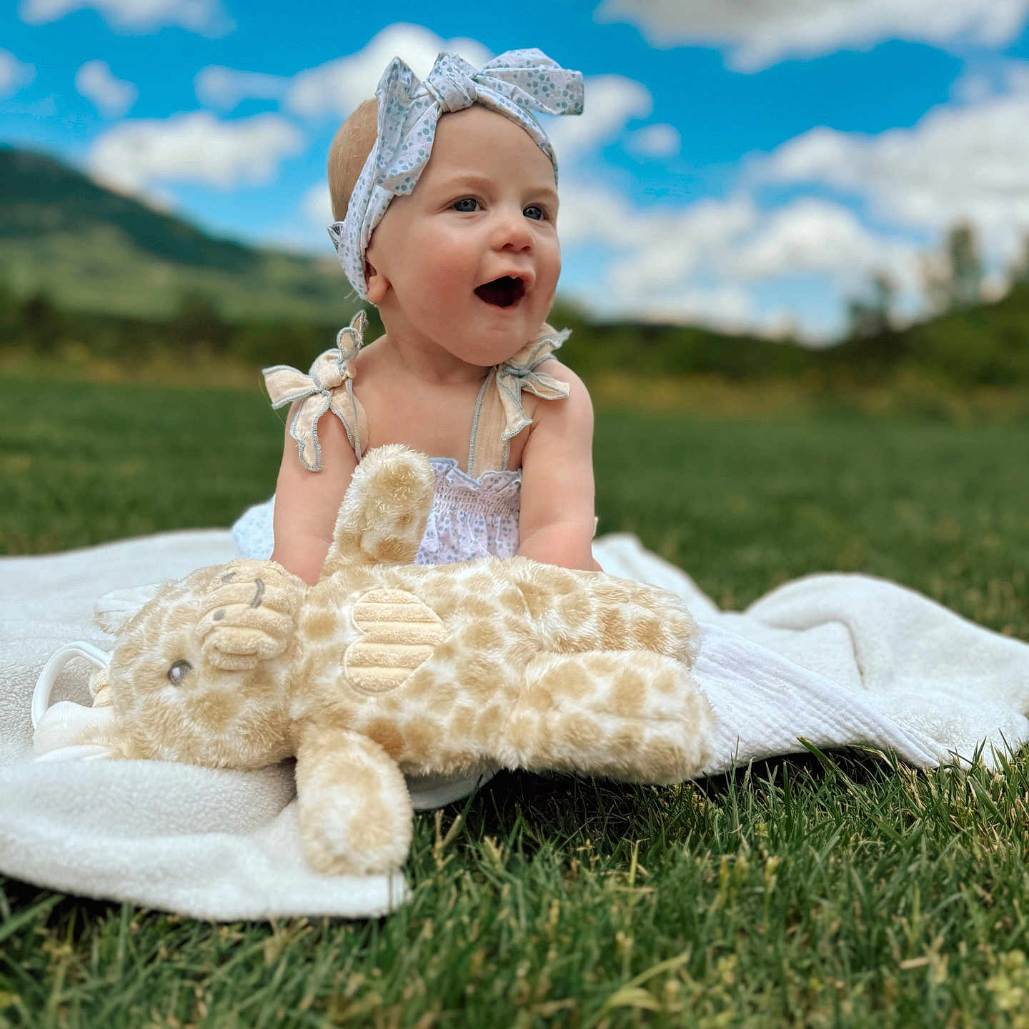 Layla joined the competition — help win amazing prizes! baby, bonnet, cap, clothing, dress, face, field, grass, grassland, happy, hat, head, lawn, nature, outdoors, person, photography, plant, portrait, summer