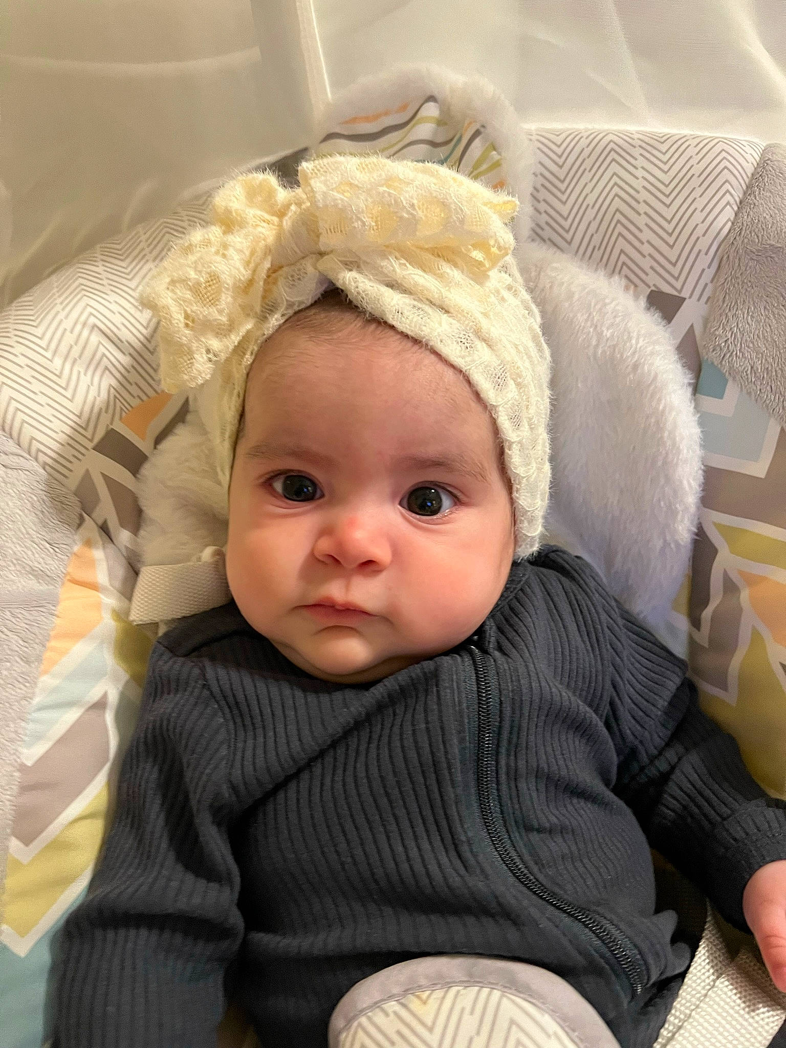 Haven is registered to the contest to win money with this photo: baby, baby_safety, baby_toddler_clothing, beanie, cheek, child, comfort, eye, eyebrow, eyelash, fashion_accessory, headgear, iris, lip, outerwear, person, sitting, skin, sleeve, toddler