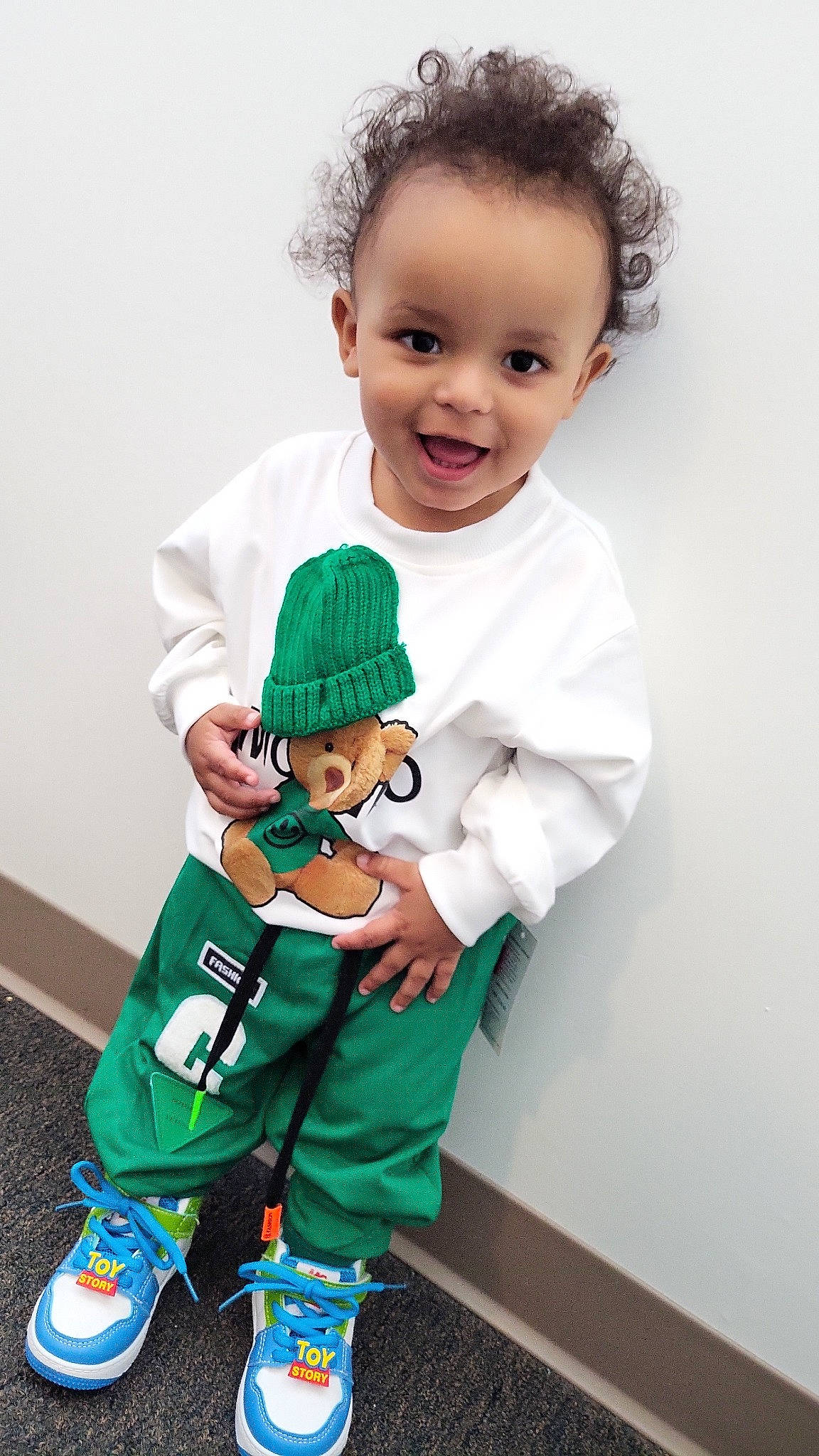 Koda joined the competition — help win amazing prizes! baby, baby_products, baby_toddler_clothing, child, fictional_character, gesture, happy, holiday, joy, outerwear, pattern, person, play, sleeve, smile, sock, stuffed_toy, t_shirt, thumb, toddler