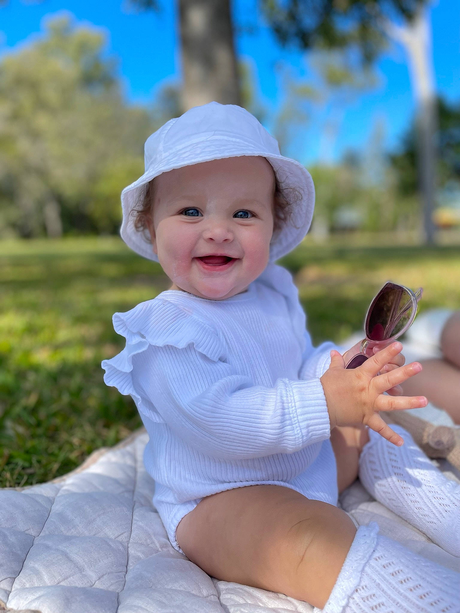 Amari joined the competition — help win amazing prizes! baby, baby_toddler_clothing, cap, eye, fun, grass, hand, happy, hat, headwear, joy, leisure, mammal, person, pink, plant, shorts, skin, sky, smile