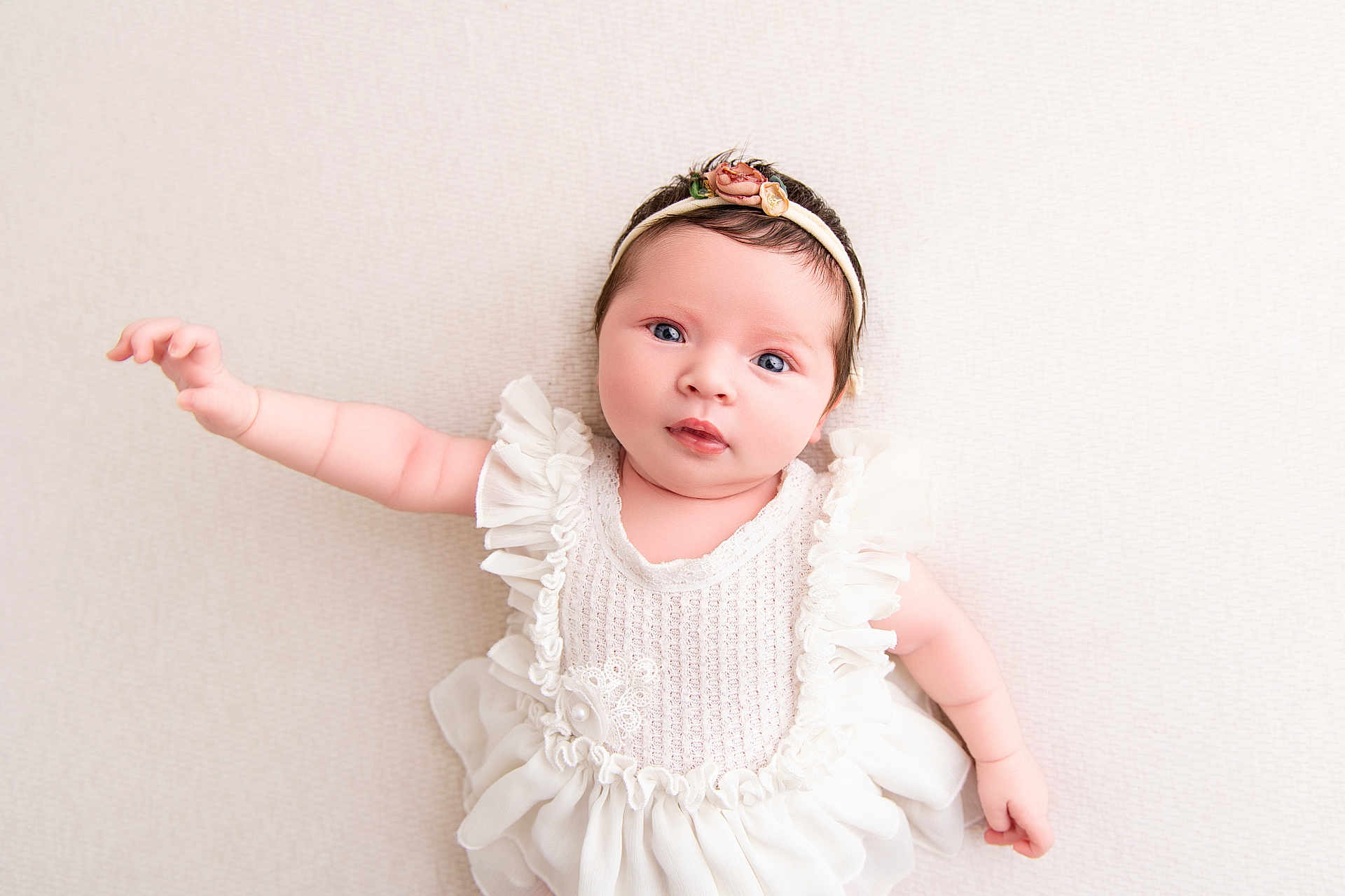 Lolah joined the competition — help win amazing prizes! baby, infant, child, blue_eyes, white_dress, headband, floral, cute, portrait, closeup, soft_light, lying_down, skin, hand, face, expression, newborn, adorable, innocence, soft_texture