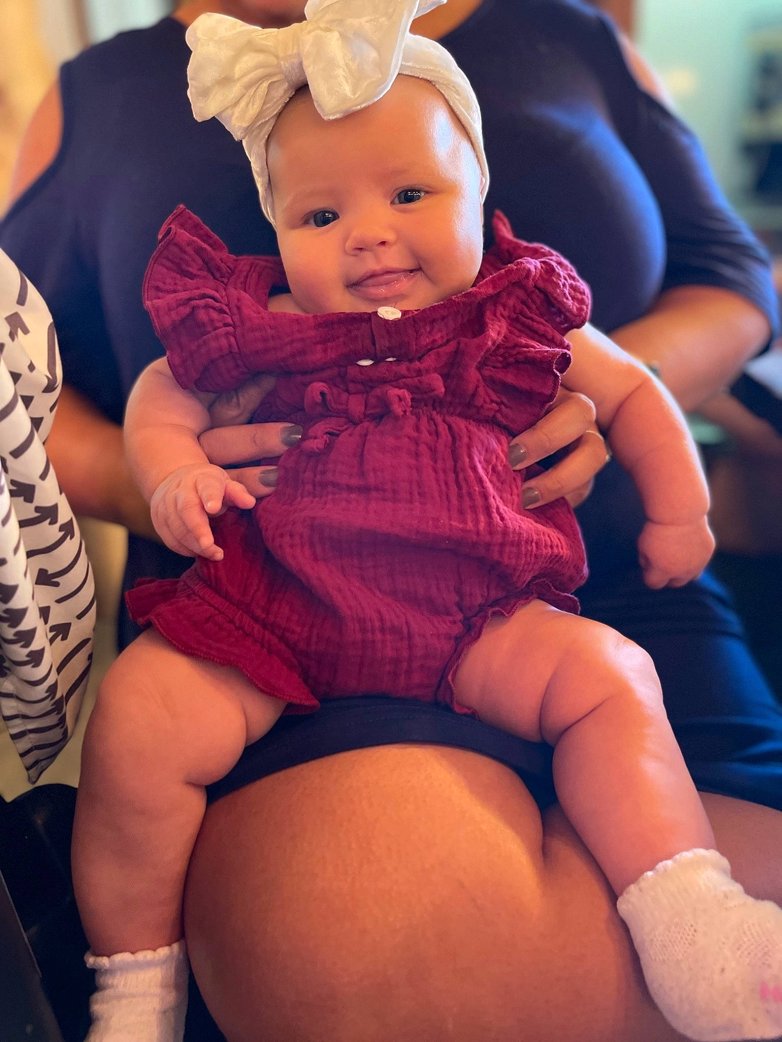 Regina is registered to the contest to win money with this photo: baby, baby_toddler_clothing, dress, eye, fashion, finger, happy, hat, headgear, headwear, iris, lap, leg, organ, people, person, photograph, pink, purple, skin