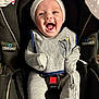 baby, infant, smiling, car_seat, clothing, white_hat, grey_outfit, seatbelt, happy, child, person, indoor, blanket, fabric, safety, cute, young, headwear, apparel, baby_bib