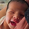 newborn, baby, infant, sleeping, yawning, face, portrait, close_up, cuddled, blanket, pink, swaddled, adorable, indoors, soft_lighting, close_face, dark_hair, eyes_closed, parent, cozy