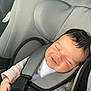 baby, car_seat, infant, smiling, sleeping, child, seatbelt, safety, cute, clothing, head_support, person, young, transportation, car_interior, seat, resting, hands, comfort, nap