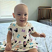 Brooklyn joined the competition — help win amazing prizes! baby, child, smiling, dress, bed, blanket, window, crib, indoor, person, cute, happy, sitting, infant, mickey_mouse, pattern, room, light, clothing, playful