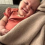 Hadley is registered to the contest to win money with this photo: baby, smiling, sleepy, blanket, knit, cozy, infant, cute, portrait, person, sleep, rest, indoors, soft, comfort, clothing, closeup, head, peaceful, happy
