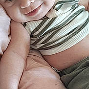 Bryson joined the competition — help win amazing prizes! baby, smile, infant, striped_clothing, blanket, soft, cute, lying_down, green_pants, skin, fist, child, young, cheerful, cozy, portrait, indoor, comfortable, closeup, happy