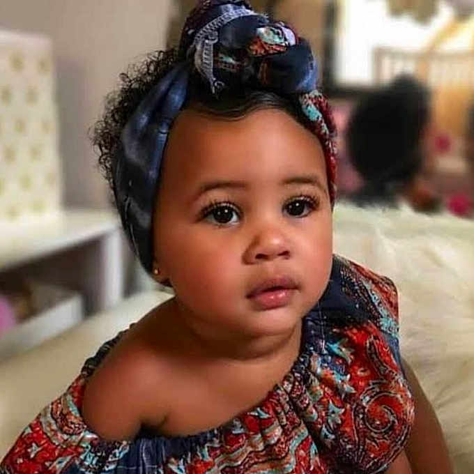 Mandipa joined the competition — help win amazing prizes! baby, beautiful, candid, child, closeup, colorful_clothing, curly_hair, ethnic_wear, expression, face, fashion, headwrap, indoor, looking_away, person, portrait, skin, soft_lighting, toddler, young_child