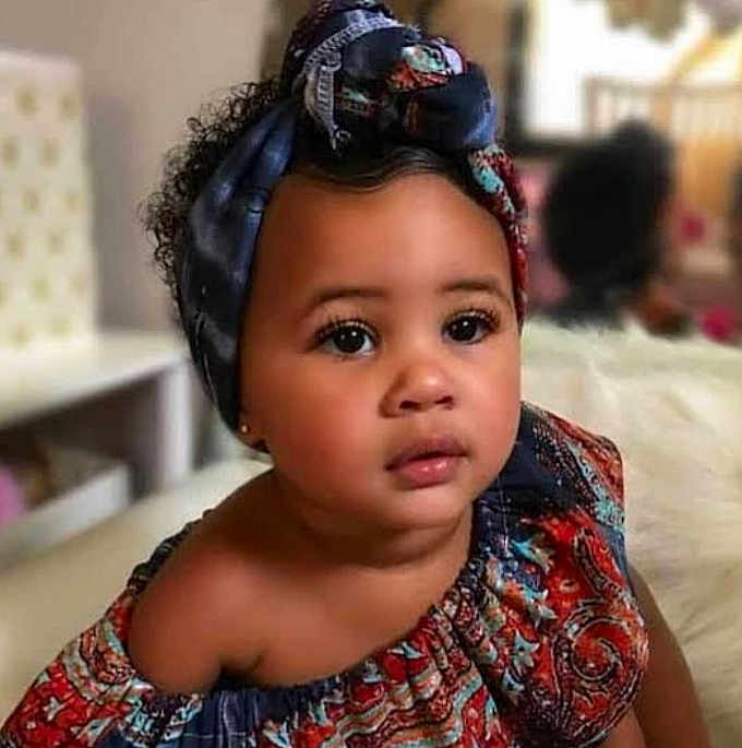 Mandipa joined the competition — help win amazing prizes! toddler, child, portrait, face, headwrap, colorful_clothing, indoor, curly_hair, looking_away, young_child, candid, beautiful, skin, expression, closeup, person, fashion, ethnic_wear, soft_lighting, baby