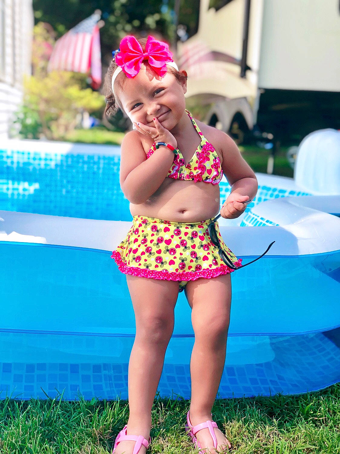 Lily Rose joined the competition — help win amazing prizes! child, clothing, design, fun, grass, happy, inflatable, joy, leg, pattern, person, pink, plant, polka_dot, smile, summer, swimming_pool, swimwear, toddler, vacation