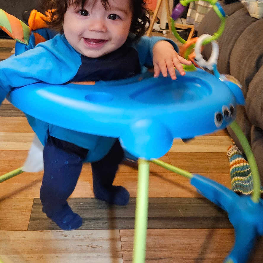 Jose is registered to the contest to win money with this photo: baby, boy, clothing, coat, computerhardware, electronics, face, furniture, hardware, hardwood, head, indoors, interiordesign, monitor, person, photography, portrait, screen, tv, wood