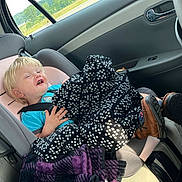 Caden joined the competition — help win amazing prizes! toddler, child, car_seat, blanket, blue_shirt, brown_boots, car_interior, seatbelt, window, bottle, happy, smiling, blond_hair, clothing, seat, door, plastic_bottle, road_trip, travel, casual