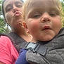Caden joined the competition — help win amazing prizes! child, woman, toddler, baby_carrier, outdoor, greenery, curly_hair, blonde_hair, pink_shirt, face, pucker_lips, closeup, portrait, person, nature, family, bonding, daylight, casual, expression