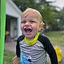background, blurred, casual_clothing, child, daytime, fun, green, happy, joyful, laughing, octopus_design, outdoor, person, playtime, smiling, summer, swim_shirt, toddler, trampoline, wet_hair