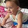 toddler, child, baby, crawling, smiling, indoors, bedspread, clothing, shorts, tank_top, happy, skin, hair, person, cute, playful, young_child, expression, face, hand