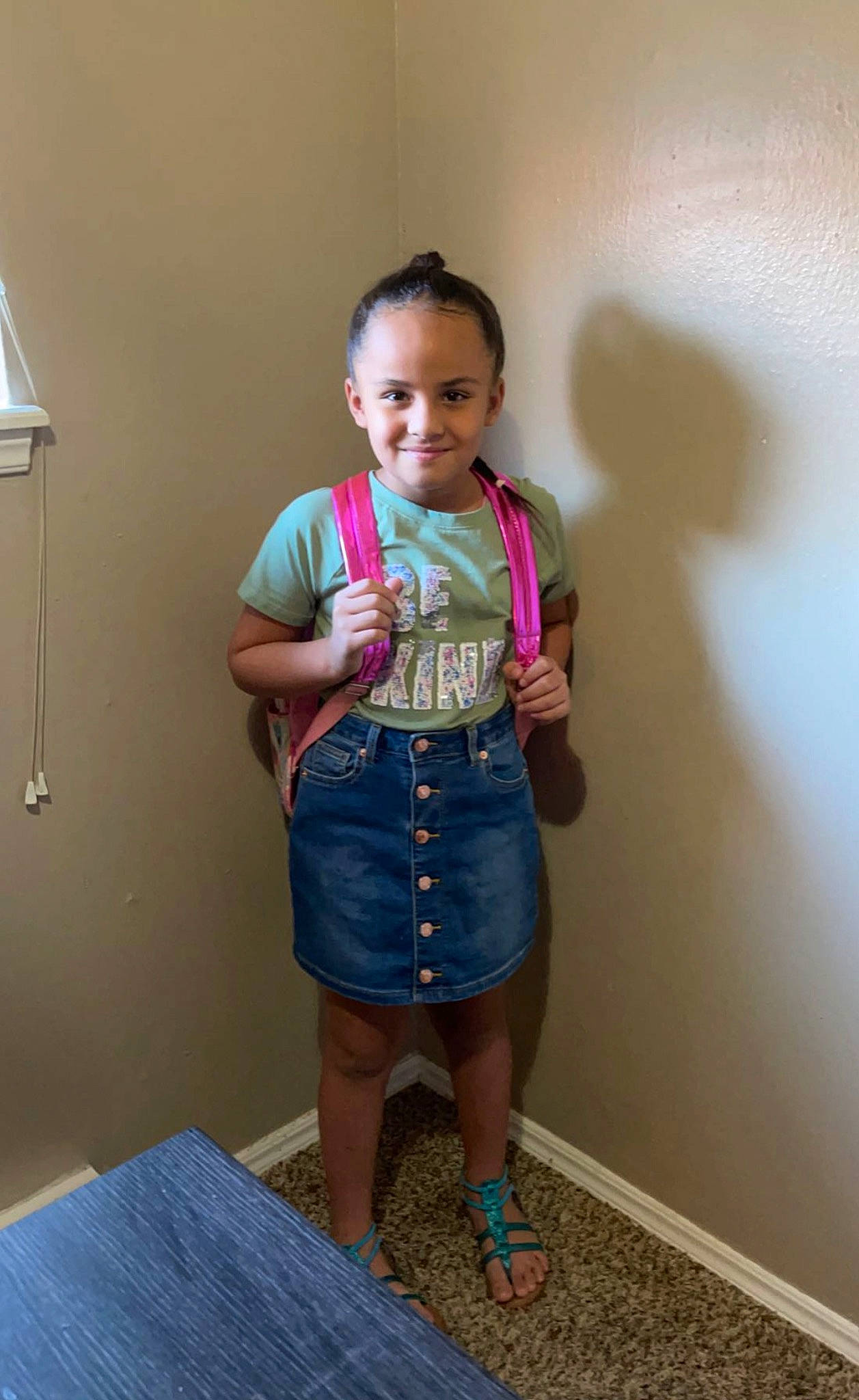 Anaya is registered to the contest to win money with this photo: arm, baby_toddler_clothing, clothing, door, face, flooring, fun, happy, human_leg, joint, joy, knee, lamp, leg, pattern, person, sleeve, smile, standing, t_shirt