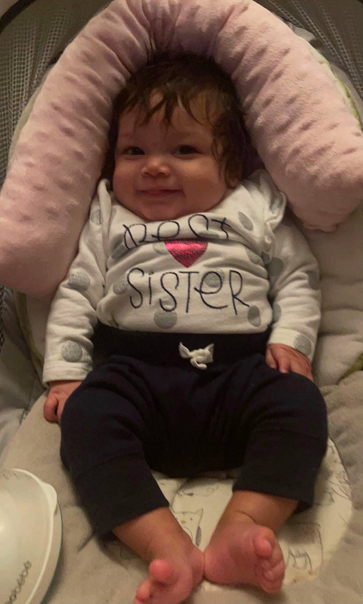 Isla is registered to the contest to win money with this photo: arm, baby, baby_toddler_clothing, cheek, chin, comfort, cool, facial_expression, finger, hairstyle, happy, head, human, mouth, person, photograph, shoulder, skin, sleeve, textile