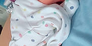 Amelia is registered to the contest to win money with this photo: arm, baby, bedroom, blanket, care, clothing, comfort, face, head, holding, hospital, indoor, newborn, person, polka_dot, rest, skin, snuggling, soft, wristband