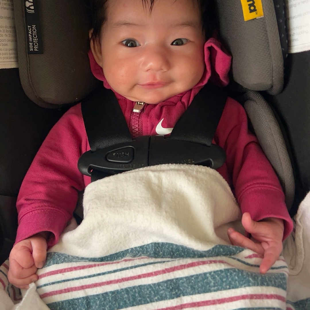 Haseena joined the competition — help win amazing prizes! baby, blanket, buckle, car_seat, cozy, cute, fabric, hair, hands, harness, head_support, hoodie, indoors, infant, newborn, nike_logo, portrait, safety, seat_padding, smile
