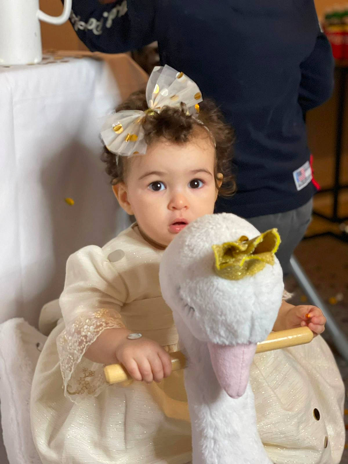 Sogia participe au concours pour gagner de l'argent avec cette photo : baby, baby_toddler_clothing, bridal_accessory, chair, child, dress, embellishment, event, face, fur, gown, hairstyle, happy, headband, headpiece, person, petal, pink, skin, surprise