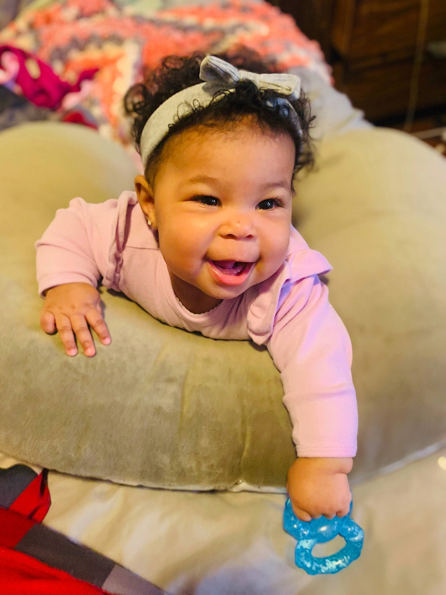 Novah is registered to the contest to win money with this photo: baby, baby_toddler_clothing, cheek, child, comfort, face, facial_expression, fun, gesture, grass, happy, iris, leisure, magenta, person, pink, red, sitting, skin, smile