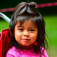 Lucia is registered to the contest to win money with this photo: child, girl, smile, pink_shirt, topknot, hair, face, outdoor, nature, green_background, portrait, cute, happy, young, person, childhood, casual_clothing, daylight, closeup, expression