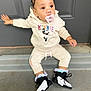 toddler, child, pacifier, hoodie, minnie_mouse, curly_hair, beads, puffs, sneakers, socks, doorstep, concrete, clothing, cute, casual, outdoor, person, baby, fashion, young_child