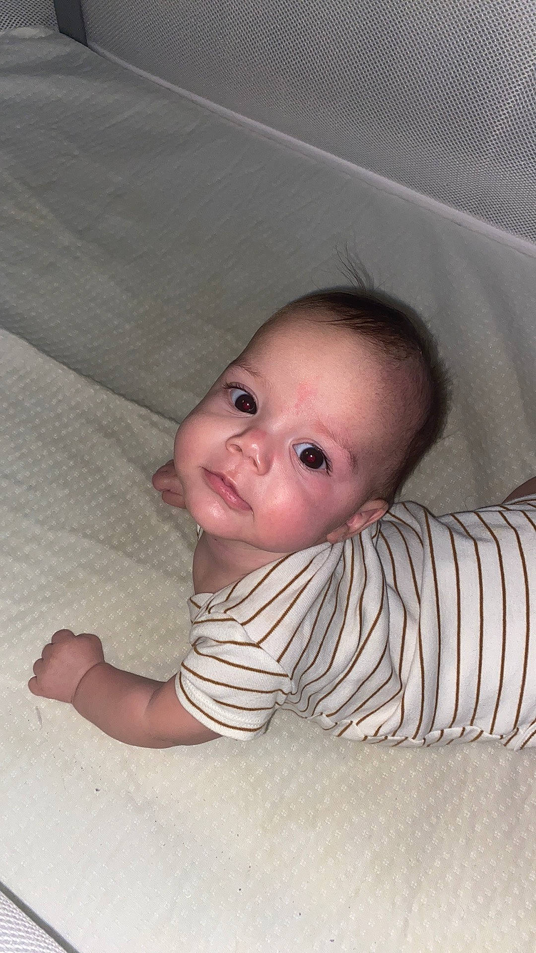 Augustine is registered to the contest to win money with this photo: baby, baby_toddler_clothing, cheek, child, chin, comfort, crawling, floor, flooring, hardwood, iris, lip, nose, pattern, person, sitting, skin, sleeve, toddler, tummy_time