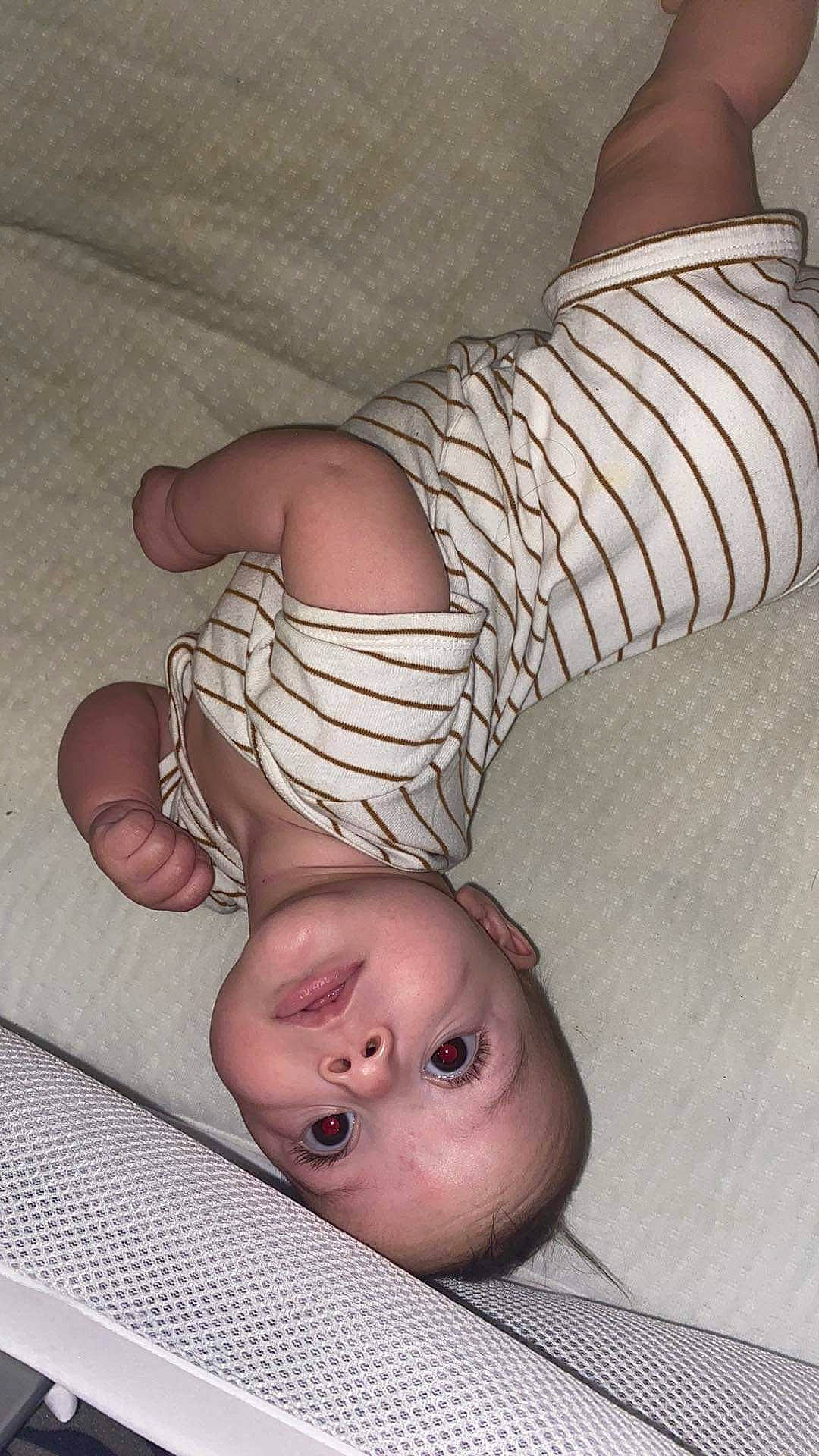 Augustine is registered to the contest to win money with this photo: arm, baby, baby_toddler_clothing, cheek, chest, child, comfort, eyelash, flesh, foot, gesture, happy, human_body, human_leg, mouth, pattern, person, skin, thigh, thumb