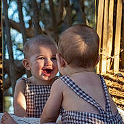 Camille participe au concours pour gagner de l'argent avec cette photo : baby, bare_back, checkered_clothing, child, cute, daylight, happy, infant, mirror, nature, outdoor, playful, portrait, reflection, sitting, skin, smile, sunlight, trees, young_child