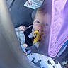 Lilah is registered to the contest to win money with this photo: baby, child, car_seat, teether, purple_canopy, blanket, infant, toy, blue_eyes, soft_lighting, seatbelt, cute, indoors, comfort, person, young_child, head, hand, fabric, closeup