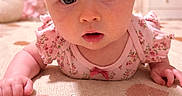 Lilah joined the competition — help win amazing prizes! baby, infant, face, eyes, pink_clothing, floral_pattern, blanket, heart_pattern, nursery, soft_lighting, curious_expression, crawling, child, indoors, cute, portrait, closeup, young_child, adorable, baby_girl