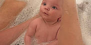 Bonnie is registered to the contest to win money with this photo: baby, bath, bubbles, water, arm, child, skin, foam, cute, infant, parent, care, tub, clean, relax, splash, happy, support, washing, indoors