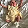 Bonnie joined the competition — help win amazing prizes! baby, infant, smiling, yellow_dress, white_socks, frills, lying_down, arms_outstretched, cute, happy, face, skin, head, eyes, mouth, tongue, fabric, blanket, soft, indoors
