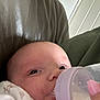 Bonnie is registered to the contest to win money with this photo: baby, bottle, feeding, milk, hand, face, closeup, infant, couch, leather, clothing, pink, nail_polish, skin, person, indoors, young_child, comfort, rest, expression