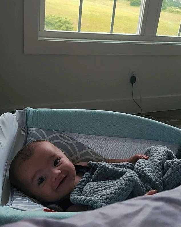 Lawson joined the competition — help win amazing prizes! baby, child, comfort, couch, glass, human, light, linens, mammal, nap, person, room, shade, sitting, tints_and_shades, toddler, tree, vehicle_door, white, window