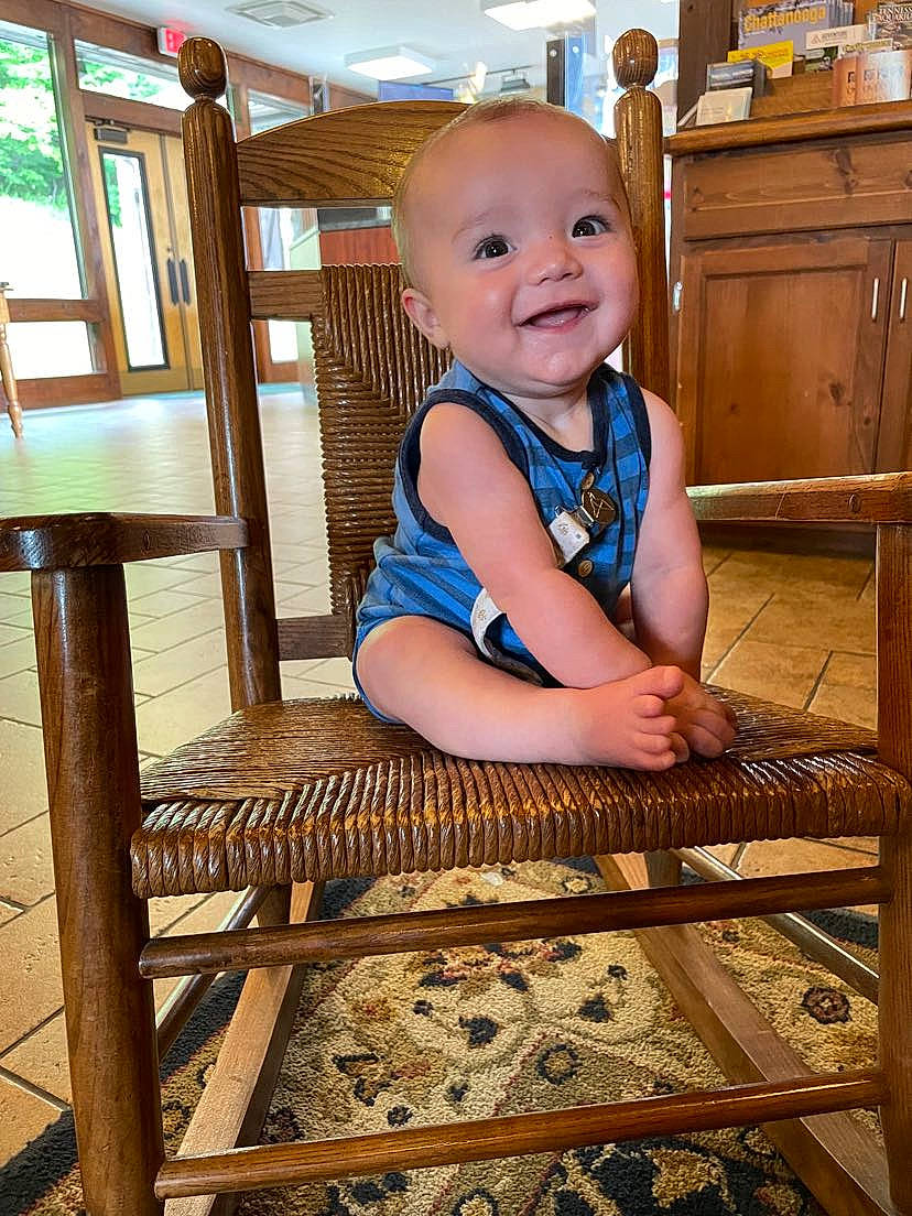 Lawson is registered to the contest to win money with this photo: baby, baby_safety, baby_toddler_clothing, cabinetry, chair, chest_of_drawers, child, drawer, floor, flooring, happy, hardwood, joy, leisure, person, product, room, smile, stairs, standing