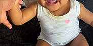 Ivy is registered to the contest to win money with this photo: accessories, baby, bodypart, clothing, couch, diaper, face, finger, footwear, furniture, hand, happy, head, person, photography, portrait, sandal, shoe, sitting, smile