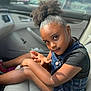 Brooklynn is registered to the contest to win money with this photo: arm, black_shirt, car_interior, casual_clothing, child, curious_look, denim_overalls, door, earrings, face, girl, hairstyle, high_puff, portrait, seat, sitting, skin, sunlight, window, young