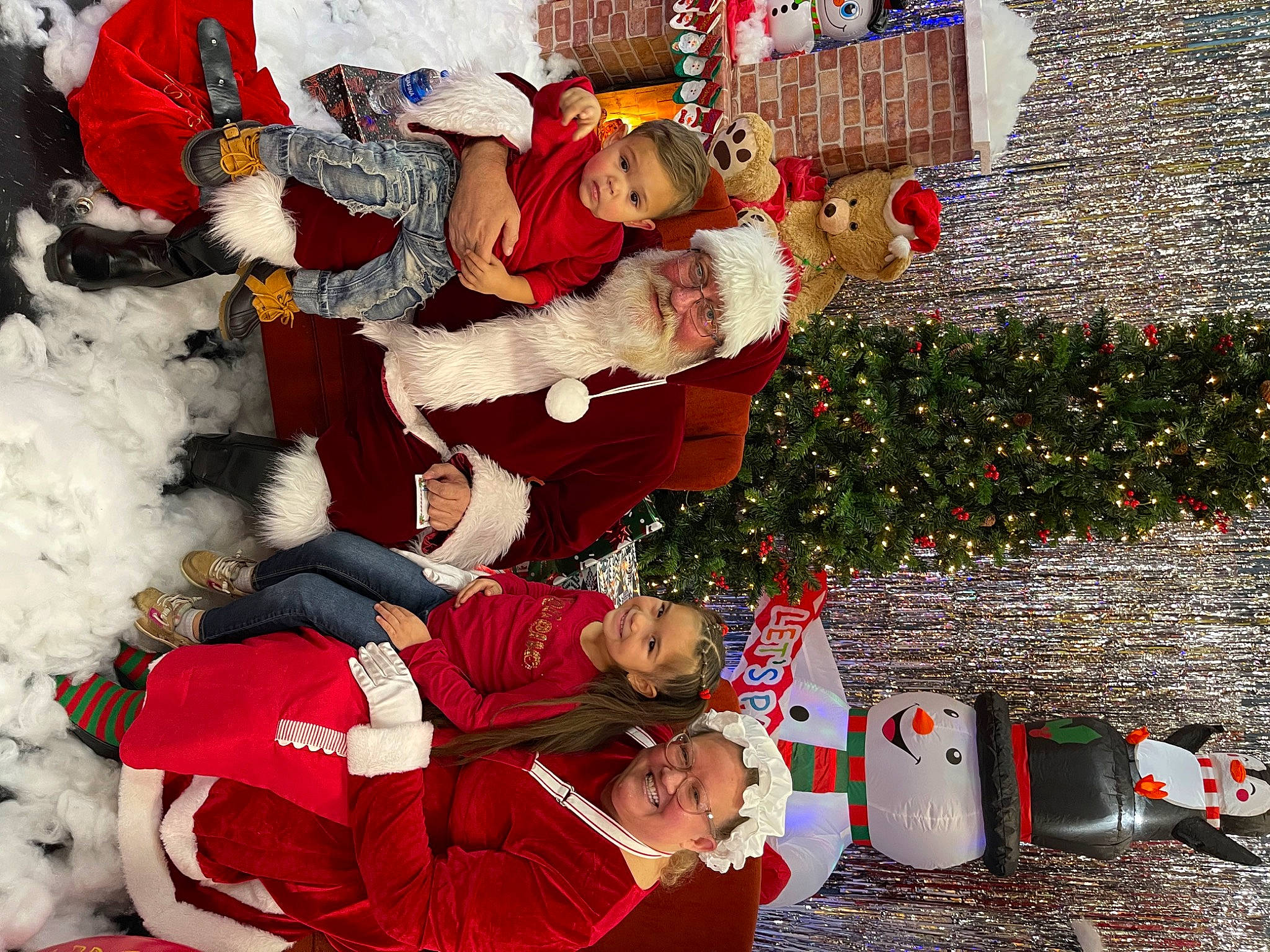 Luisa is registered to the contest to win money with this photo: carmine, christmas, christmas_decoration, christmas_eve, christmas_ornament, christmas_tree, event, fun, happy, hat, headwear, holiday, holiday_ornament, joy, lap, person, plant, red, santa_claus, tradition