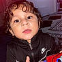 Elijah joined the competition — help win amazing prizes! toddler, child, curly_hair, black_jacket, nike, toy, indoor, carpet, face, eyes, hand, zipper, person, clothing, young_child, curiosity, portrait, closeup, brown_eyes, home