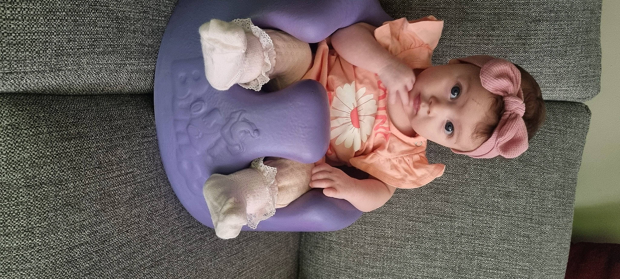 Amara is registered to the contest to win money with this photo: baby, baby_products, baby_toddler_clothing, cheek, child, comfort, dress, finger, gesture, grass, hand, hat, linens, person, pink, room, sitting, skin, thumb, toddler